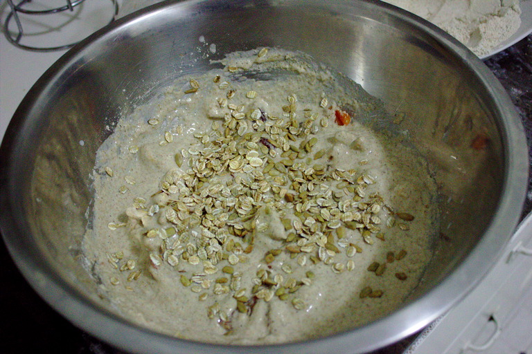 Dough in a batter-like consistency with seeds and flakes